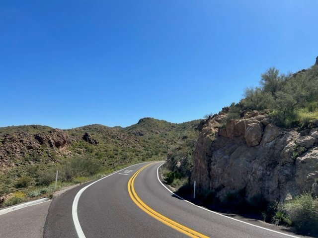 A road winds through rocky outcrops along the way to Tortilla Flat.